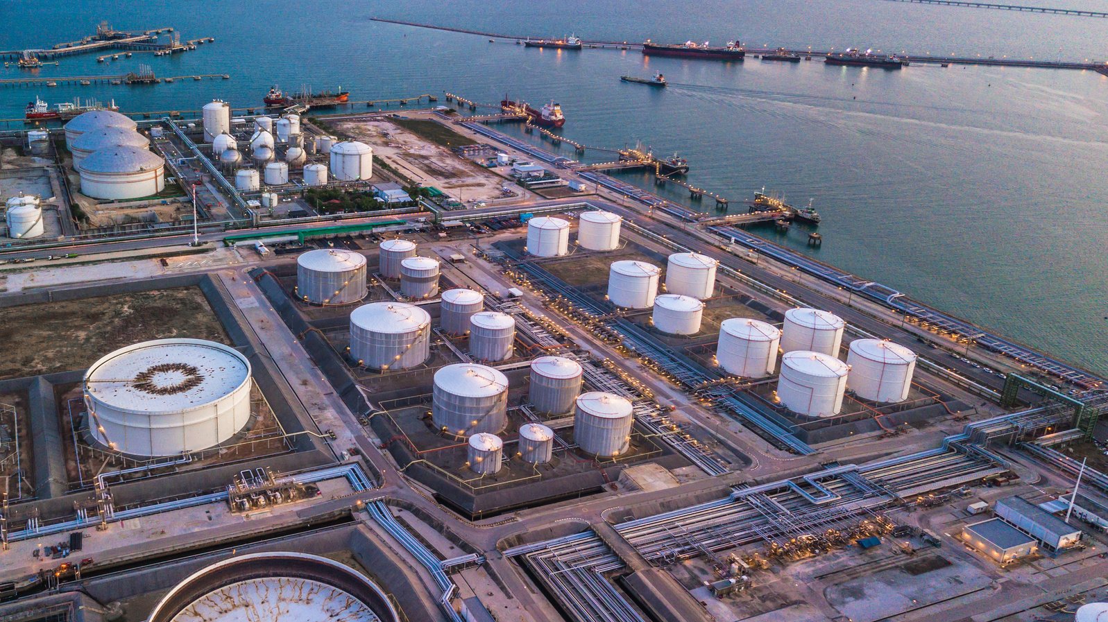 Aerial view oil terminal is industrial facility for storage of oil and petrochemical products ready for transport to further storage facilities.